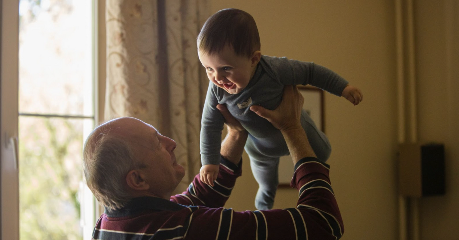 Grandad holding up child